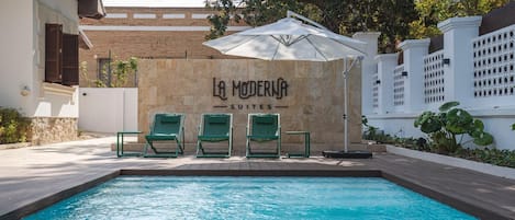 Outdoor pool, open 10:00 AM to 10:00 PM, pool umbrellas, pool loungers