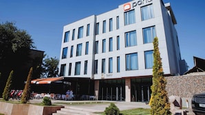A modern building with a TARY restaurant on the ground floor. - Pana Boutique Hotel (Shymkent)
