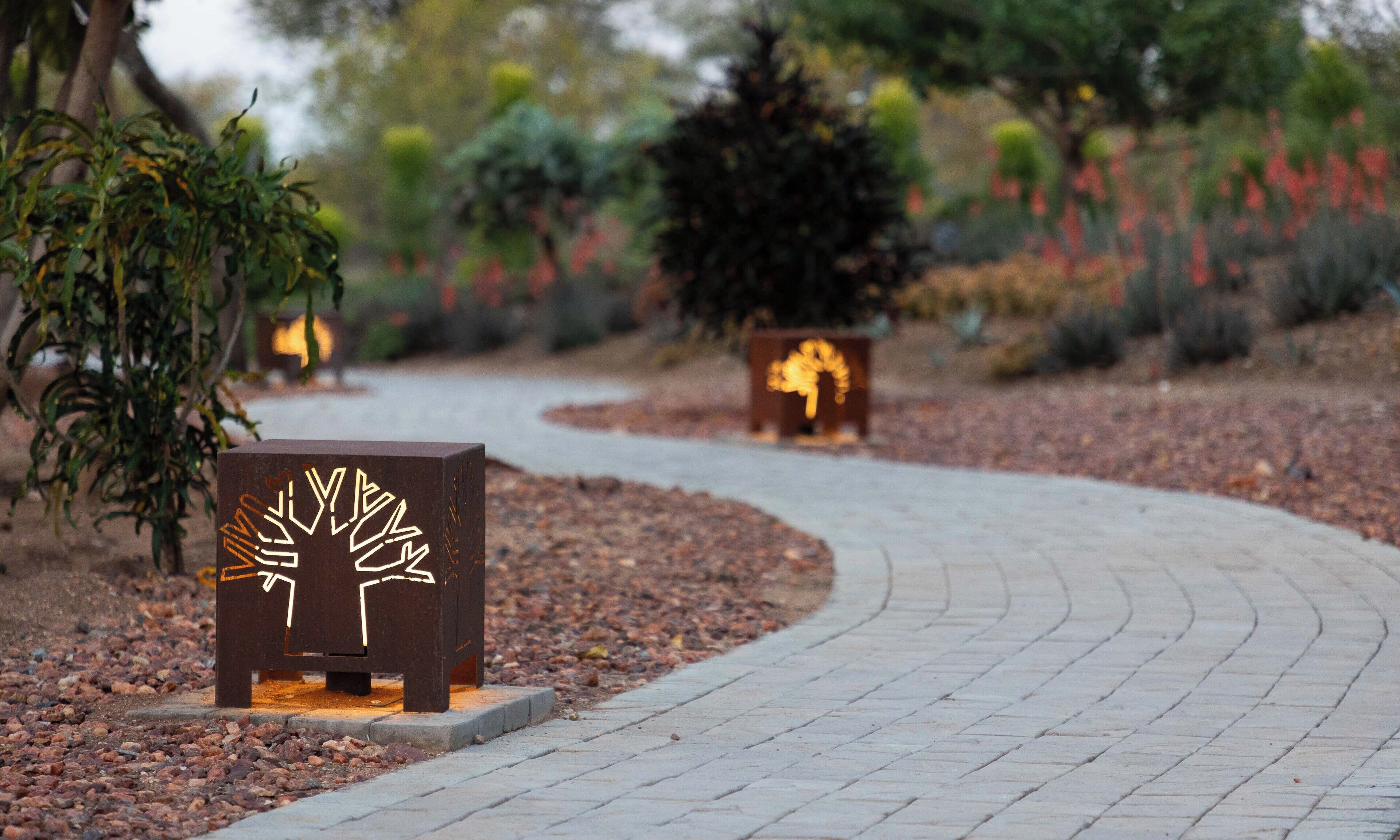 A pathway with decorative planters and a bench.