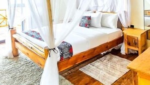 A wooden four-poster bed with a white canopy, a wooden nightstand, and a mirror on the wall. - Bwindi Neckview Lodge (Bwindi)