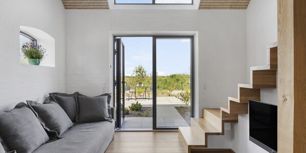 Deluxe Apartment, Garden View | Living area | TV, heated floors