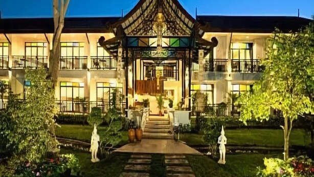 A traditional building with a central pavilion, multiple balconies, and a well-maintained garden. - Radateeree Boutique Resort (Chiang Mai)