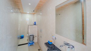 A modern bathroom with a large mirror, a shower, and a toilet. - VIBE 2.0 (Jaipur)