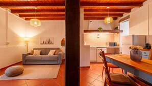 A modern living room with a sofa, dining table, and kitchen area. - Beach Lake Bellagio by Wonderful Italy (Bellagio)