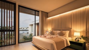 A modern hotel bedroom with a large bed, a nightstand, and a view of the cityscape. - Coco Jungle Canggu Villas by Nagisa Bali (Canggu)