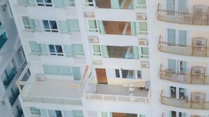 A multi-story hotel with balconies, air conditioning units, and a visible room layout. - Le Soleil Hotel (Nha Trang)