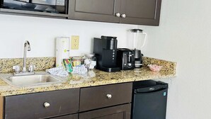 A kitchen with dark cabinets, a microwave, a coffee maker, a blender, and a dishwasher. - LA11 Great condo right on the beach+pool+Hot tub (Myrtle Beach)