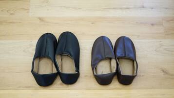 A pair of black and brown shoes on a wooden floor.