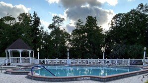 A swimming pool with a gazebo and a fenced deck area. - Beautiful Cottage! Your Home Away From Home.  4 miles from Disney, Kissimmee (Kissimmee)