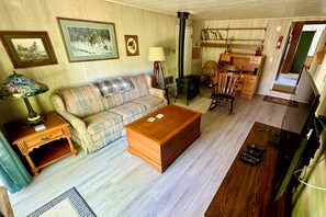 Living area - Charming 2-bedroom house with intimate Betsie River setting, AC, and WiFi (Thompsonville)