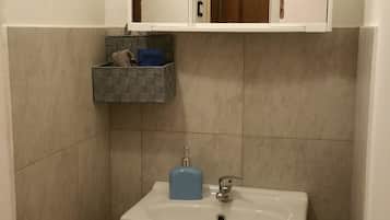 Een douche, handdoeken, zeep, shampoo