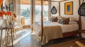 A four-poster bed with a view of the outdoors, a desk with a lamp, and a chair. - TEIMA Alentejo SW (Odemira)