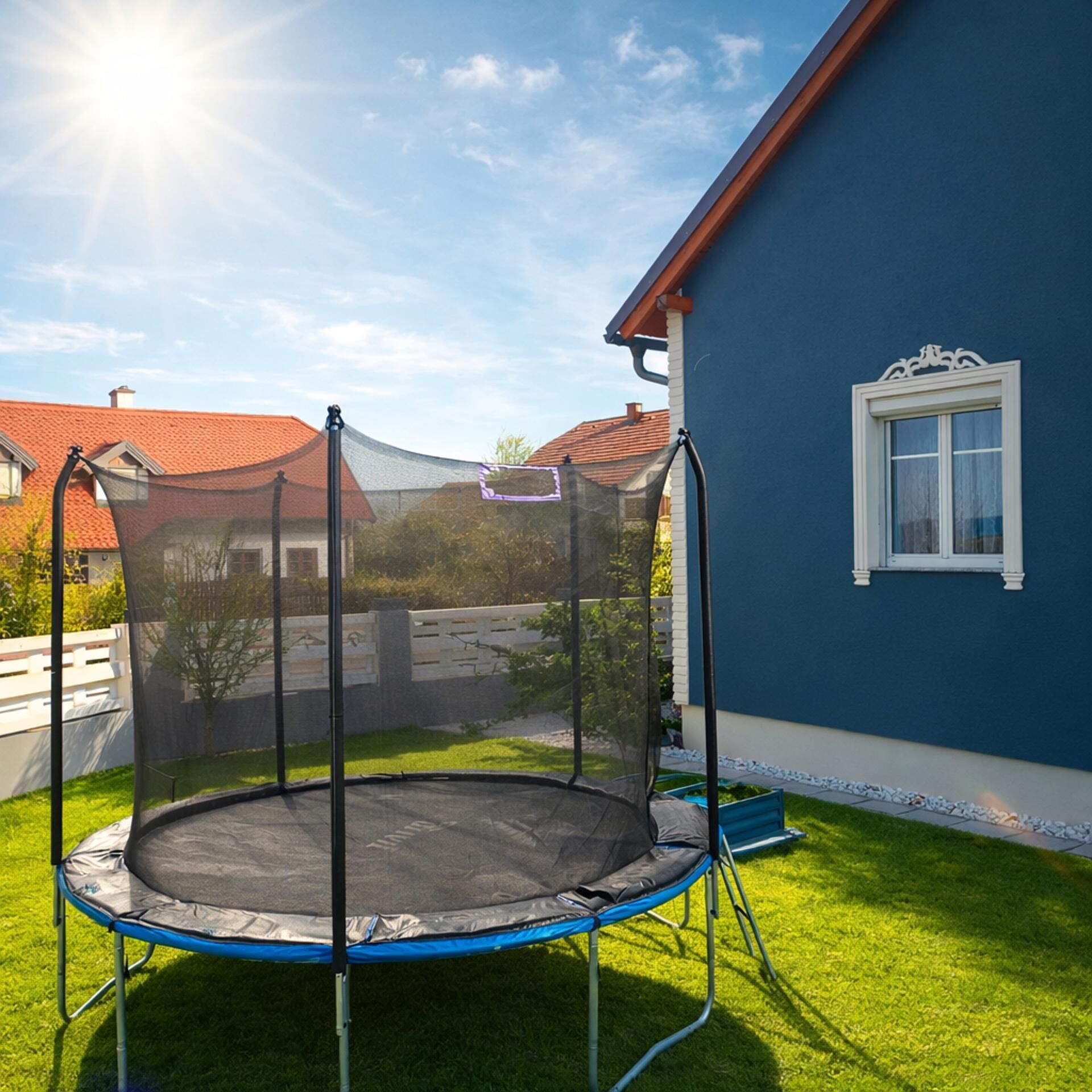 A trampoline in a backyard with a house in the background.