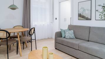 One-Bedroom Apartment | Living area | 50-inch flat-screen TV with cable channels