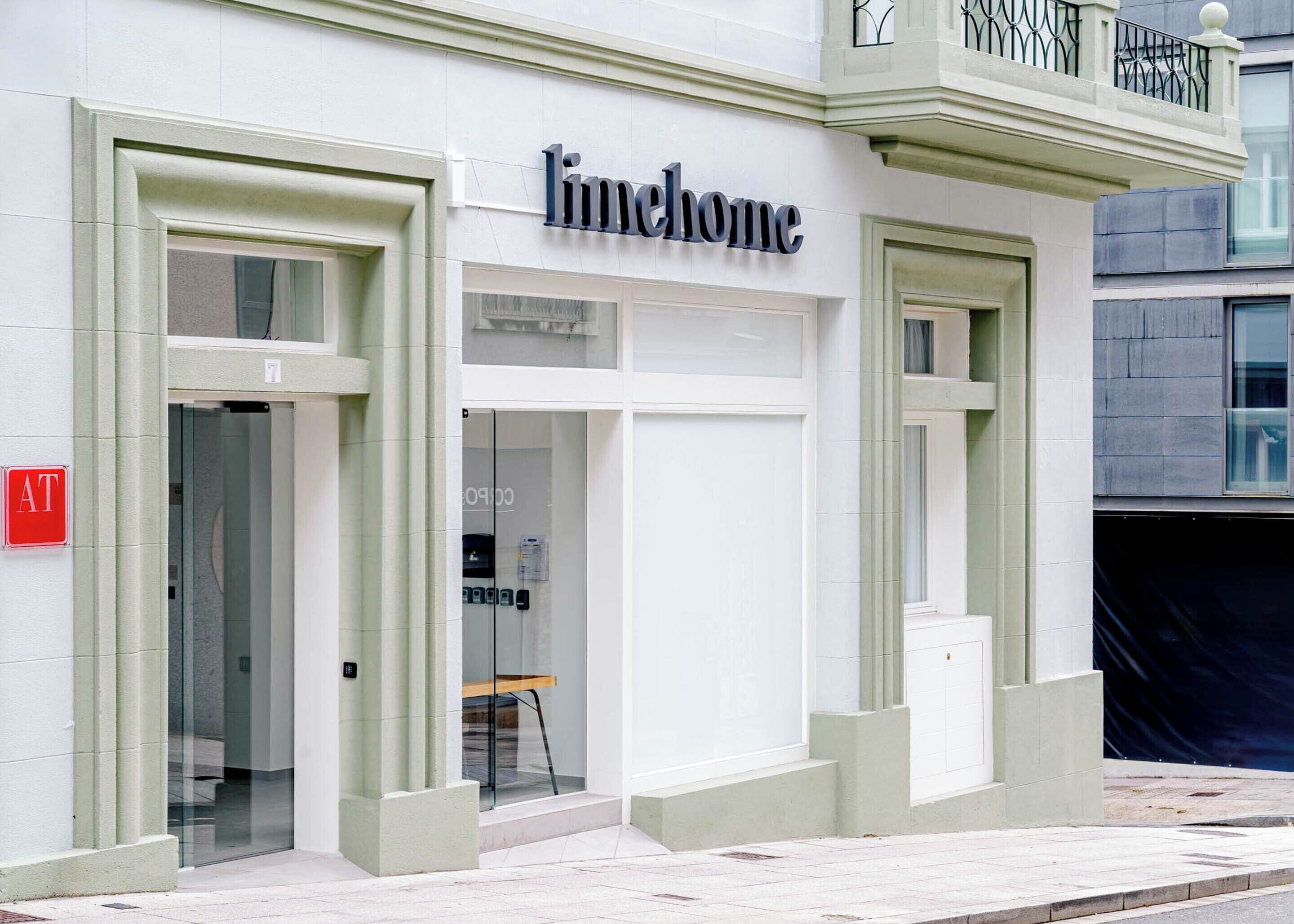 A building with a 'limhome' sign, glass doors, and a visible AT sign on the left.
