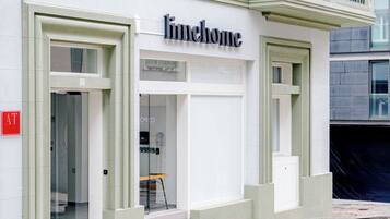 A building with a 'limhome' sign, glass doors, and a visible AT sign on the left.