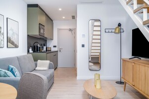 One-Bedroom Comfort Apartment | Living area | 50-inch flat-screen TV with cable channels