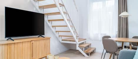 One-Bedroom Comfort Apartment | Living area | 50-inch flat-screen TV with cable channels