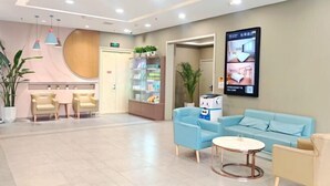 A modern hotel lobby with seating areas, a reception desk, and a digital display. - Songguo Hotel (Wenhua Road) (Zhengzhou)