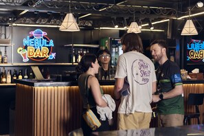 A bar with a neon sign reading "Nebula Bar" and a counter with various bottles. - 22land 52 Ngo Huyen Hotel & Spa (Hanoi)