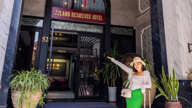 A hotel entrance with a sign reading "22LAND RESIDENCE HOTEL," a staircase, and potted plants. - 22land 52 Ngo Huyen Hotel & Spa (Hanoi)
