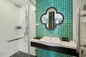 A bathroom with a white sink, a mirror, and a shower with a glass door. - 22land 52 Ngo Huyen Hotel & Spa (Hanoi)
