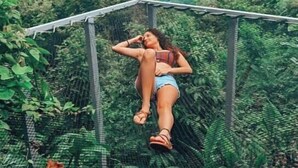 A person lying on a hammock in a lush, green forested area with mountains in the background. - AN AWESOME GLAMPING IN THE JUNGLE (Puntarenas Province)