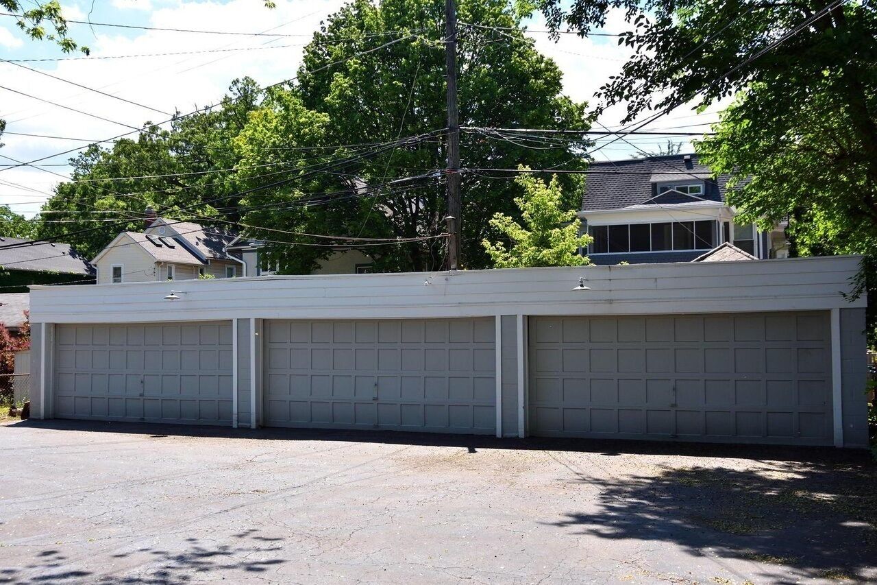 A three-car garage with a concrete driveway.