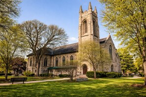 A historic church with a tall tower, surrounded by well-maintained lawns and trees. - The Oak Park Loft (Oak Park)