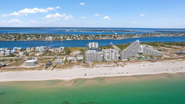 A coastal hotel with multiple buildings, a beachfront, and a marina. - Seaspray Riverside 313 (Pensacola)