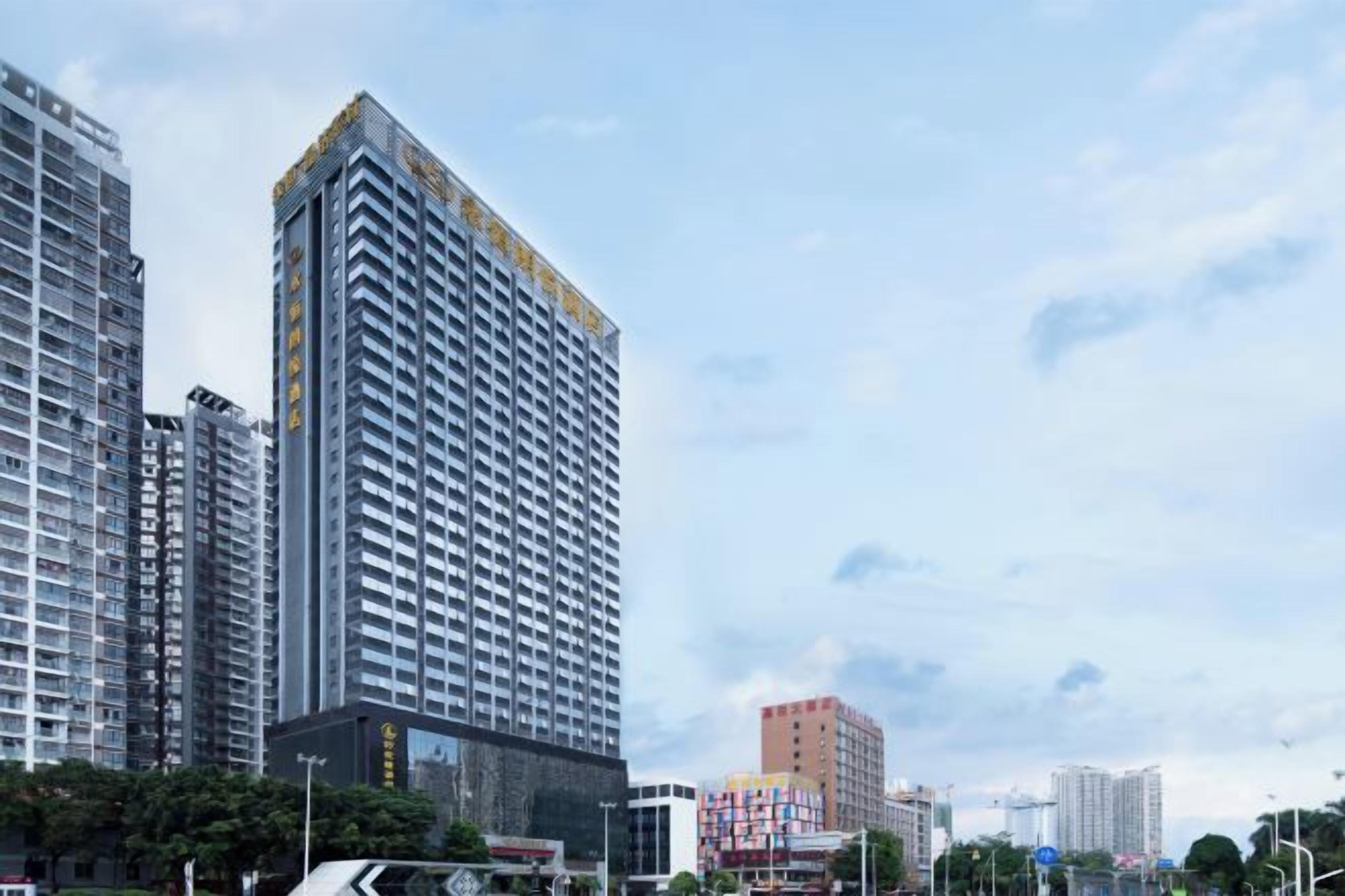A high-rise building with a modern architectural design, featuring a prominent corner structure and multiple floors.