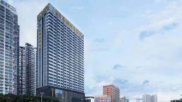 A high-rise building with a modern architectural design, featuring a prominent corner structure and multiple floors.