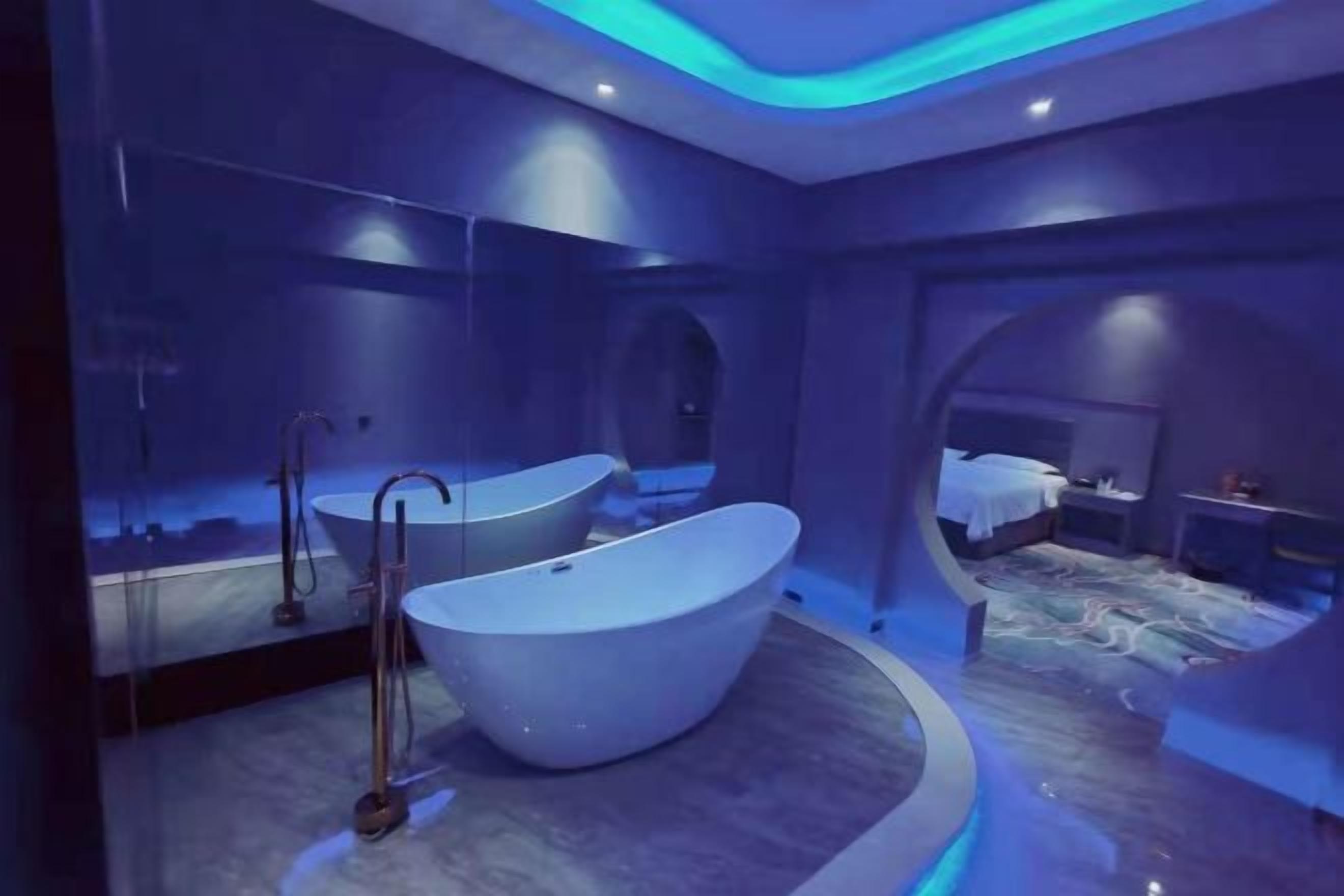 A modern bathroom with a freestanding bathtub, a mirror, and a shower.