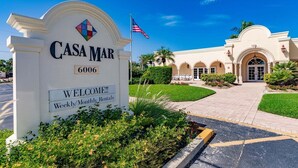 A sign for 'Casa Mar' with a welcoming message and a flag. - 65 Standard - Island Vibes - Your Perfect One-Bedroom Villa in Siesta Key Awaits (Siesta Key)