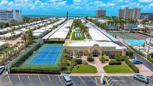 A hotel with a tennis court, parking, and a view of the ocean. - 65 Standard - Island Vibes - Your Perfect One-Bedroom Villa in Siesta Key Awaits (Siesta Key)