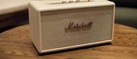 A vintage Marshall amplifier on a wooden table.