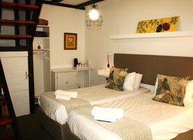 Family Quadruple Room, Courtyard View | Desk, laptop workspace, free WiFi, bed sheets