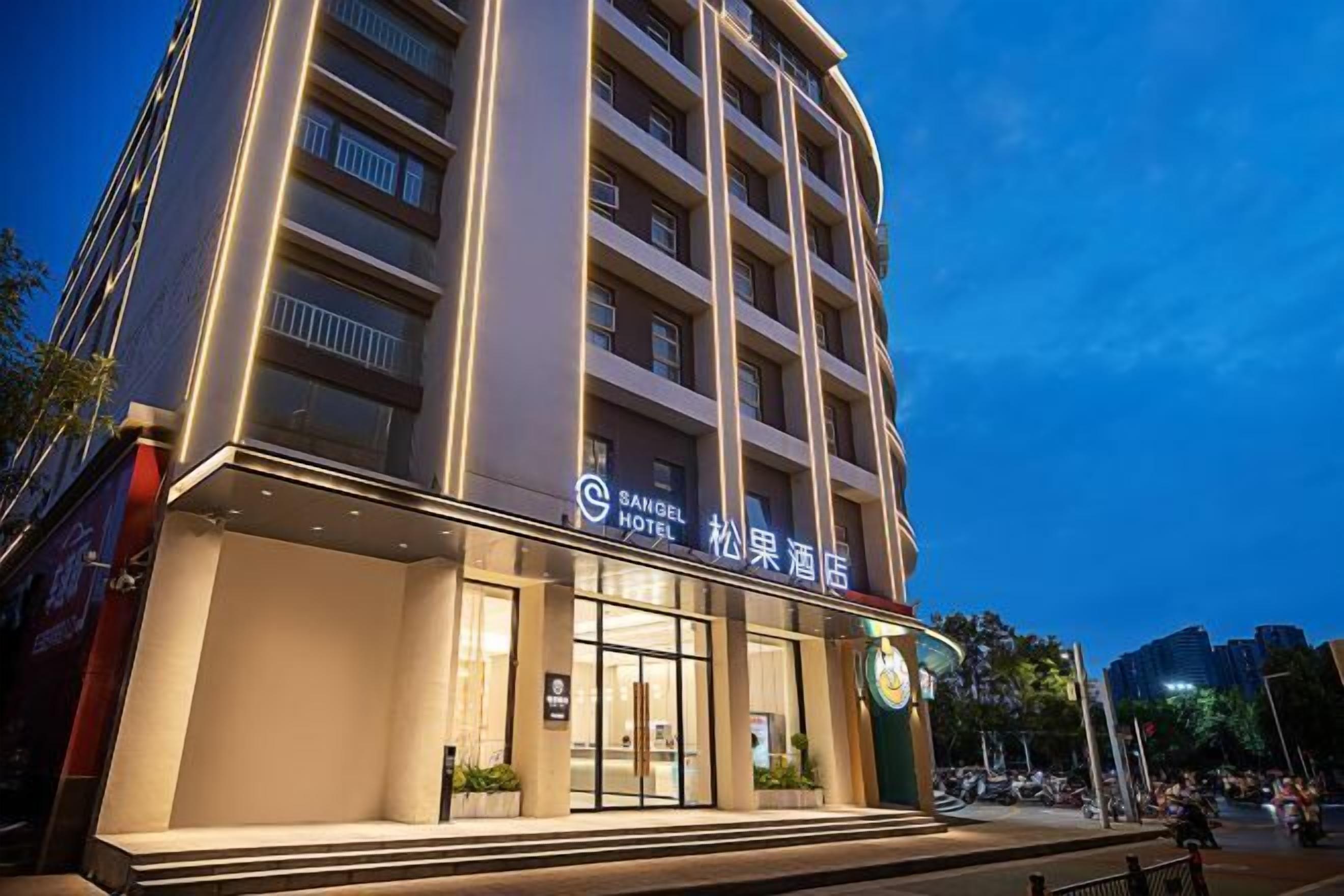 A multi-story hotel with a modern facade, large windows, and a prominent signage indicating it is the SANGEL HOTEL.