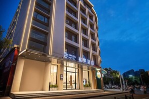 A multi-story hotel with a modern facade, large windows, and a prominent signage indicating it is the SANGEL HOTEL. - Sangel Hotel(Zhengzhou Agricultural Road Store) (Zhengzhou)
