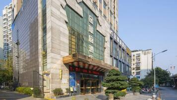 A hotel with a prominent entrance, a large sign, and a well-maintained exterior.