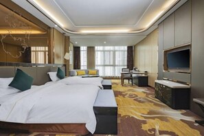 A hotel room with a large bed, a desk, a TV, and a view of the city. - Jinhuafu Hotel (Longchang)