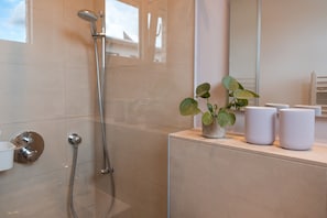 Shower, hair dryer, slippers, towels