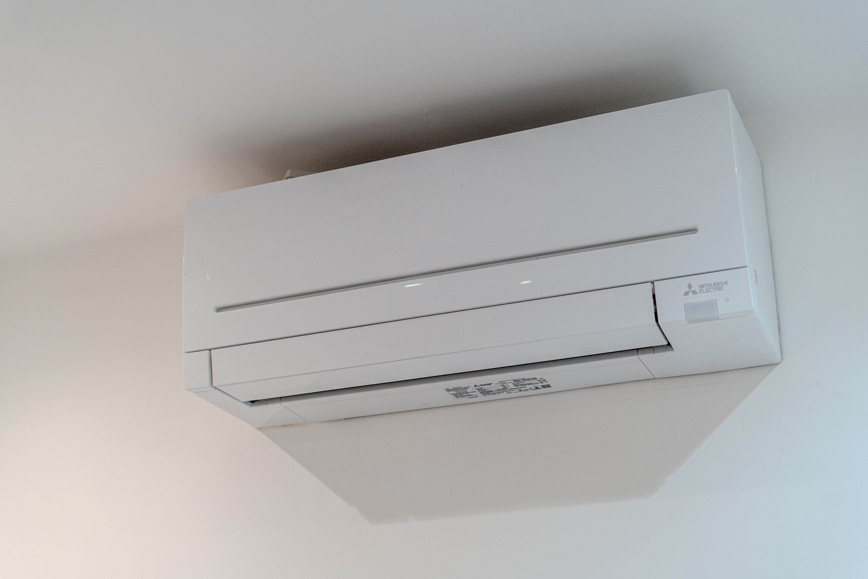 A white air conditioning unit mounted on a wall.