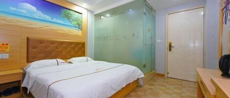 A hotel room with a bed, a wardrobe, a desk, and a painting on the wall.