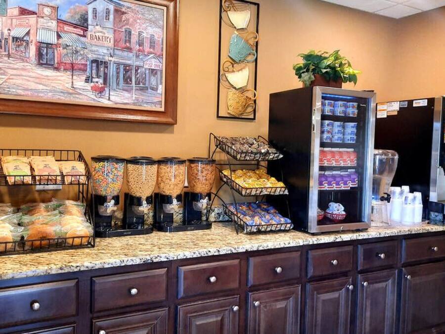 A breakfast bar with various food items and a coffee station.