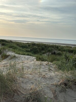 A beach with sand dunes and a clear view of the ocean. - Your home in East Frisia (Leezdorf)
