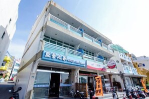 A two-story building with a ground-level shop and upper-level residential units. - Yake Hostel (Pingtung)