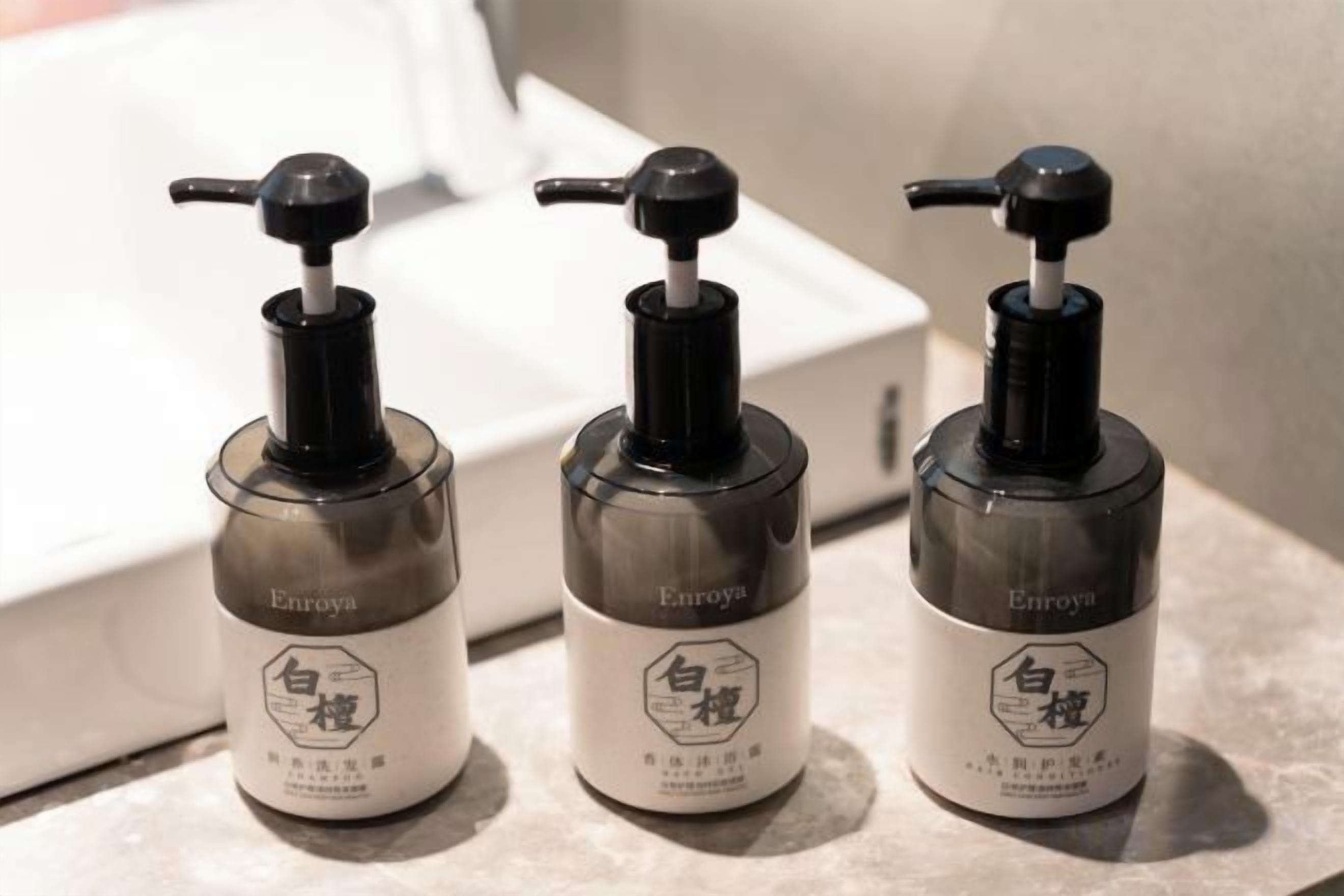 Three Enroyal hand sanitizer bottles on a marble surface.