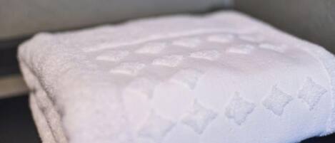 A white towel with a diamond pattern on a black surface.