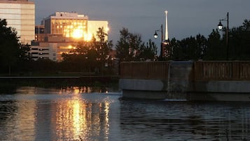 A bridge over a body of water with a cityscape in the background.